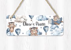 a wooden sign hanging on the side of a wall with bears and hot air balloons