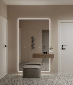 a bathroom with a sink, mirror and stool next to the door that leads to another room