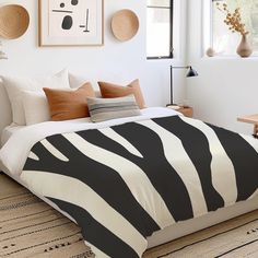 a zebra print bed spread in a white bedroom