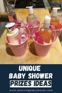 three buckets filled with baby shower products sitting on top of a wooden countertop