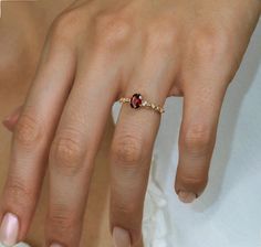 a close up of a person's hand with a ring on their finger,