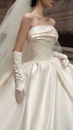 a woman in a wedding dress and gloves