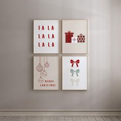 three christmas cards hanging on the wall in a room with wood floors and white walls