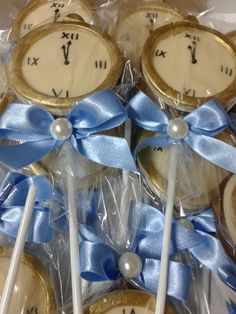 some lollipops are wrapped in plastic and have blue ribbons on them with roman numerals