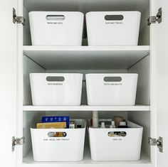 three white bins are sitting on top of a shelf