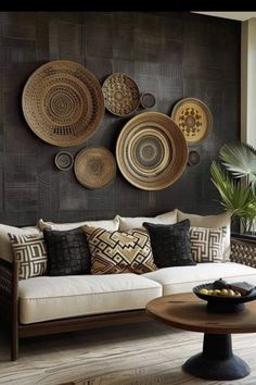 a living room filled with furniture and lots of plates hanging on the wall above it