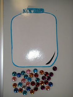 a white board with lots of different colored stones on it