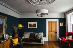 a living room filled with furniture and a chandelier