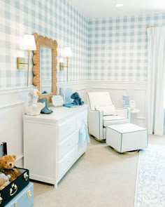 a bedroom with blue and white checkered wallpaper, two teddy bears sitting on the dresser