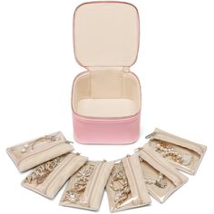 a set of jewelry in a pink case on a white background with the lid open