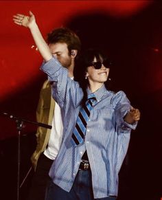 a man and woman standing next to each other on stage