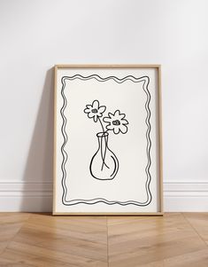 a black and white drawing of flowers in a vase on the floor next to a wall