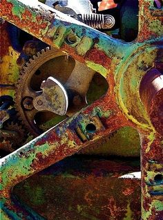 an old rusted metal structure with gears