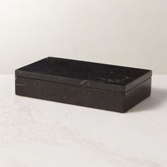 a black box sitting on top of a white counter