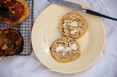 three pastries on a plate next to a cooling rack with two slices of bread