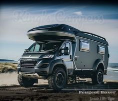 an rv is parked on the beach by the water