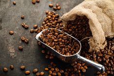 a scoop full of coffee beans on top of a table