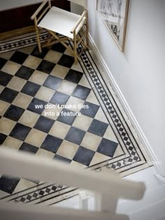 a chair sitting on top of a black and white checkered floor next to a doorway