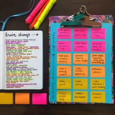 an open notebook with colorful sticky notes on it