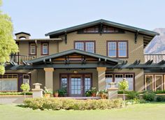 a large brown house with lots of windows