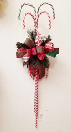 candy canes are wrapped in red and green paper to look like they have bows on them