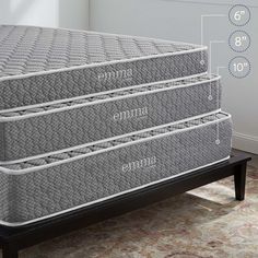 three mattresses sitting on top of each other in front of a wall with measurements