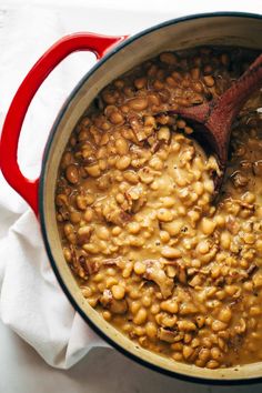 a pot filled with beans on top of a white table