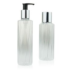 two clear glass bottles with black top and silver cap, each containing a liquid or soap dispenser