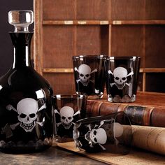 a bottle and glasses with skulls on them