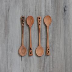 three wooden spoons and two wood utensils