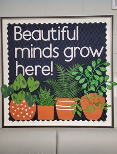 a sign that says beautiful minds grow here with potted plants on the wall behind it