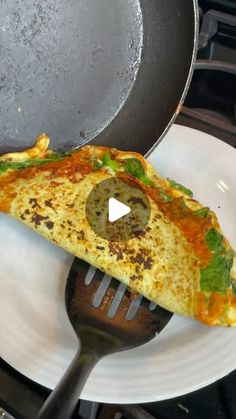 an omelet is being cooked on the stove with a spatula in it