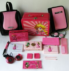 the contents of a pink and black bag are laid out on a white table top