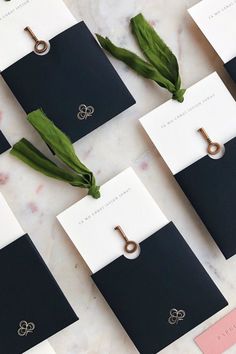 wedding stationery with rings and flowers laid out on a marble table top for guests to sign