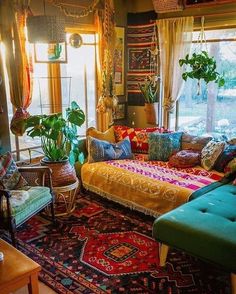 a living room filled with lots of furniture and plants on top of the windowsill