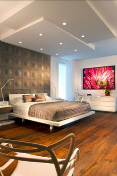 a bedroom with a large bed and wooden floors