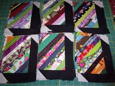 four pieces of quilted fabric laid out on a cutting board with scissors and thread