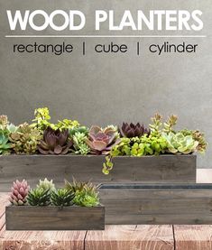 three wooden planters with succulents in them sitting on top of a table