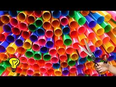 many different colored tubes are arranged in the shape of a rainbow tube, with black background