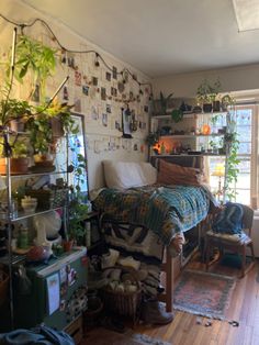 a bed room with a neatly made bed and lots of plants