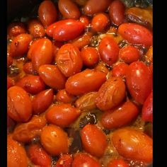 tomatoes being cooked in a pot with oil