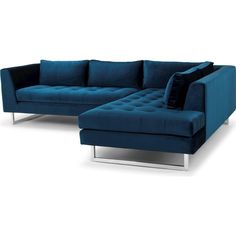 a blue sectional couch sitting on top of a white floor next to a black pillow