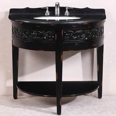 a black sink with an ornate design on it