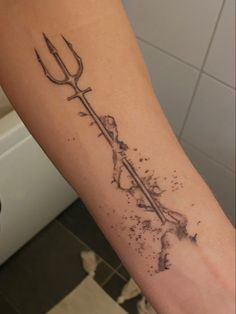 a person with a tattoo on their arm holding a fork in the middle of his arm