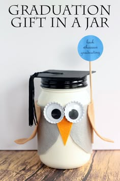 a graduation gift in a jar with an owl on top