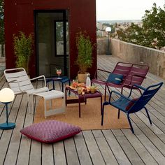 a group of chairs sitting on top of a wooden deck