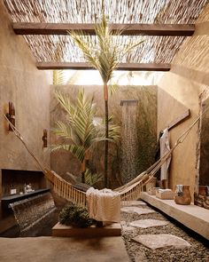 a hammock hanging from the ceiling next to a bathtub in a bathroom