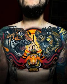 a man with tattoos on his chest has two tigers and a buddha in the center