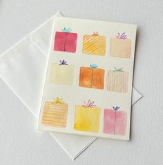 a card with watercolor presents on it