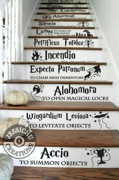 the stairs are decorated with black and white wall decals, as well as pumpkins